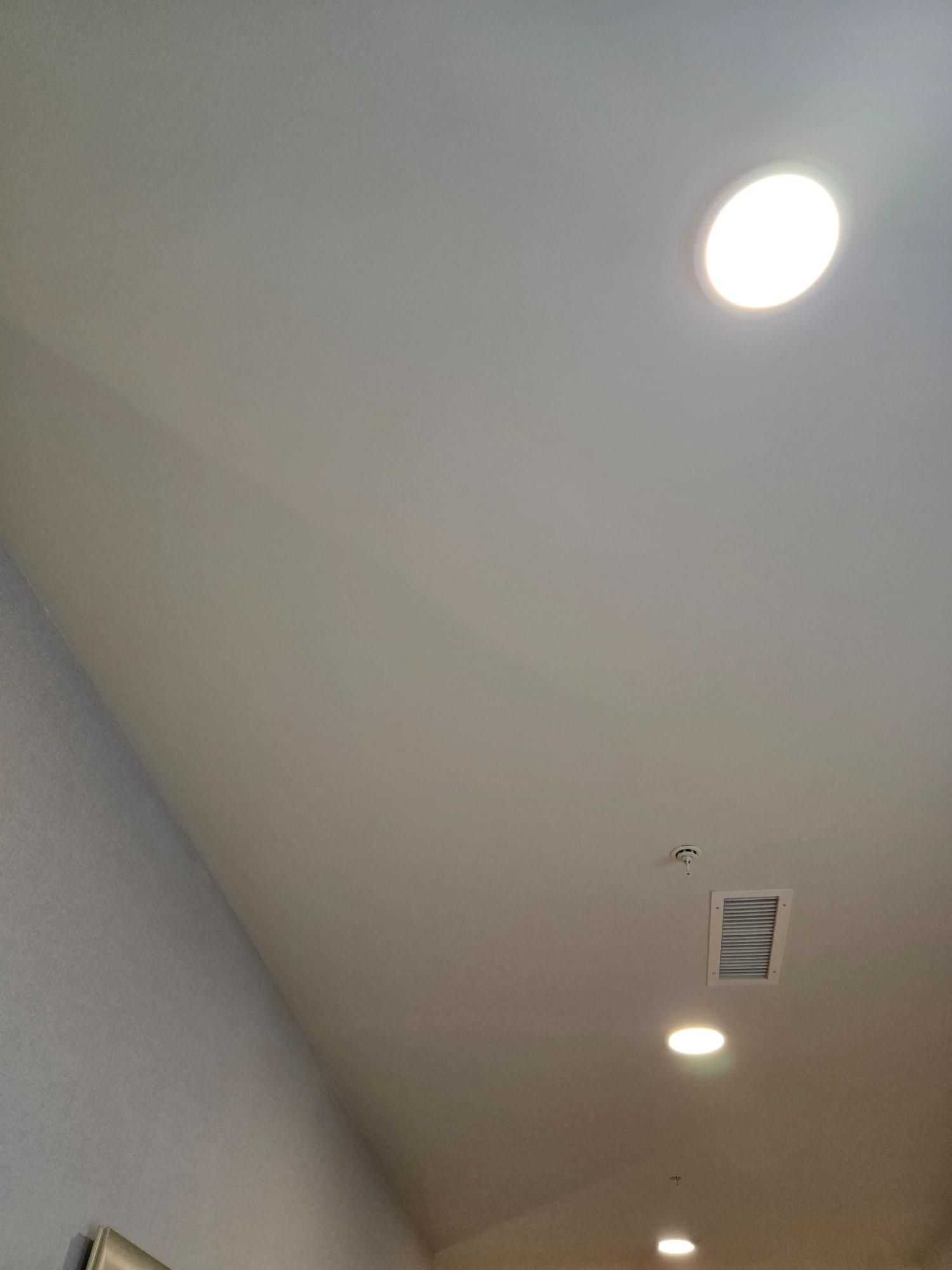 A white ceiling with a lot of lights on it.