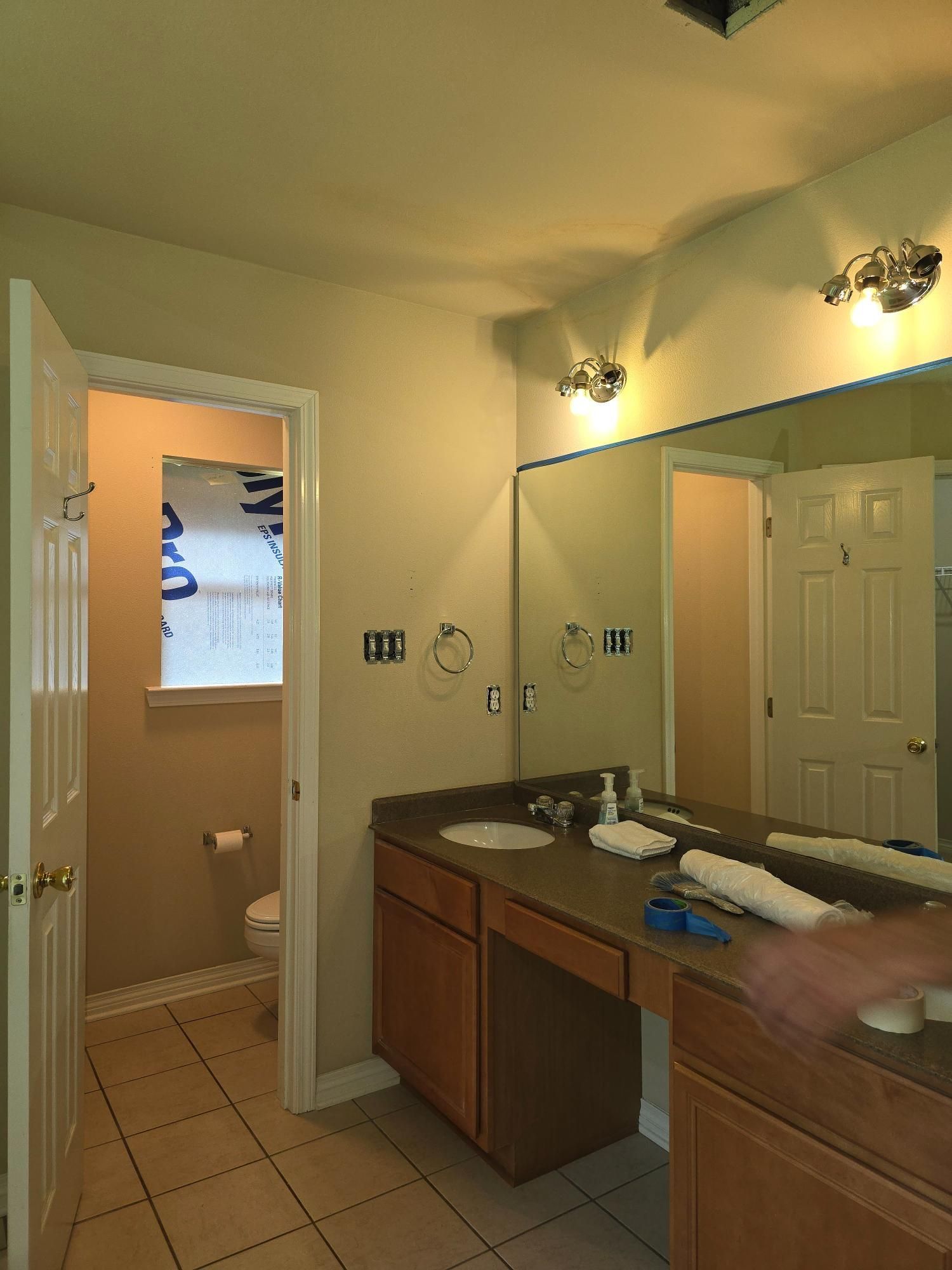 A bathroom with two sinks and a large mirror