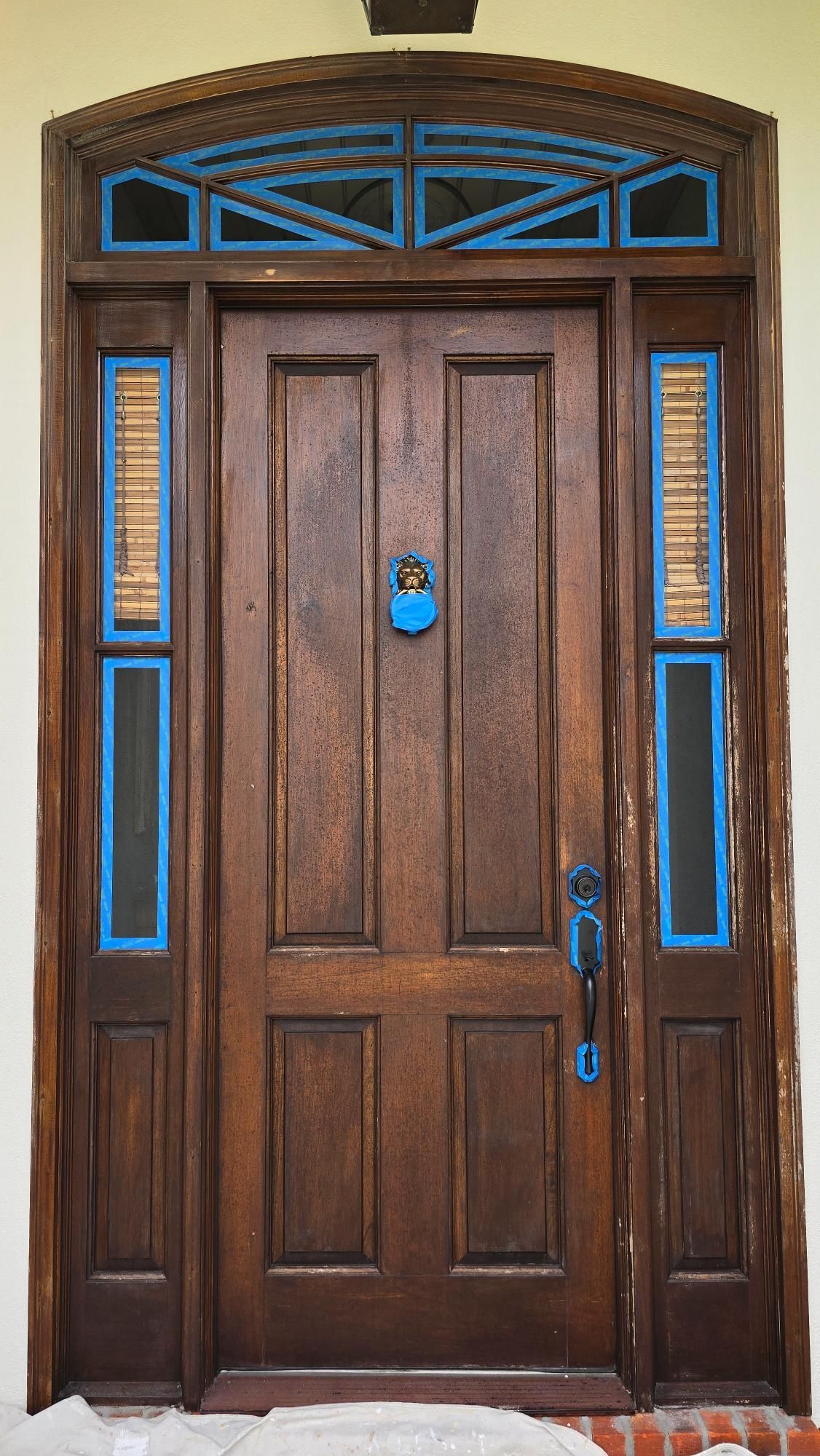 A wooden door with blue trim and a padlock on it