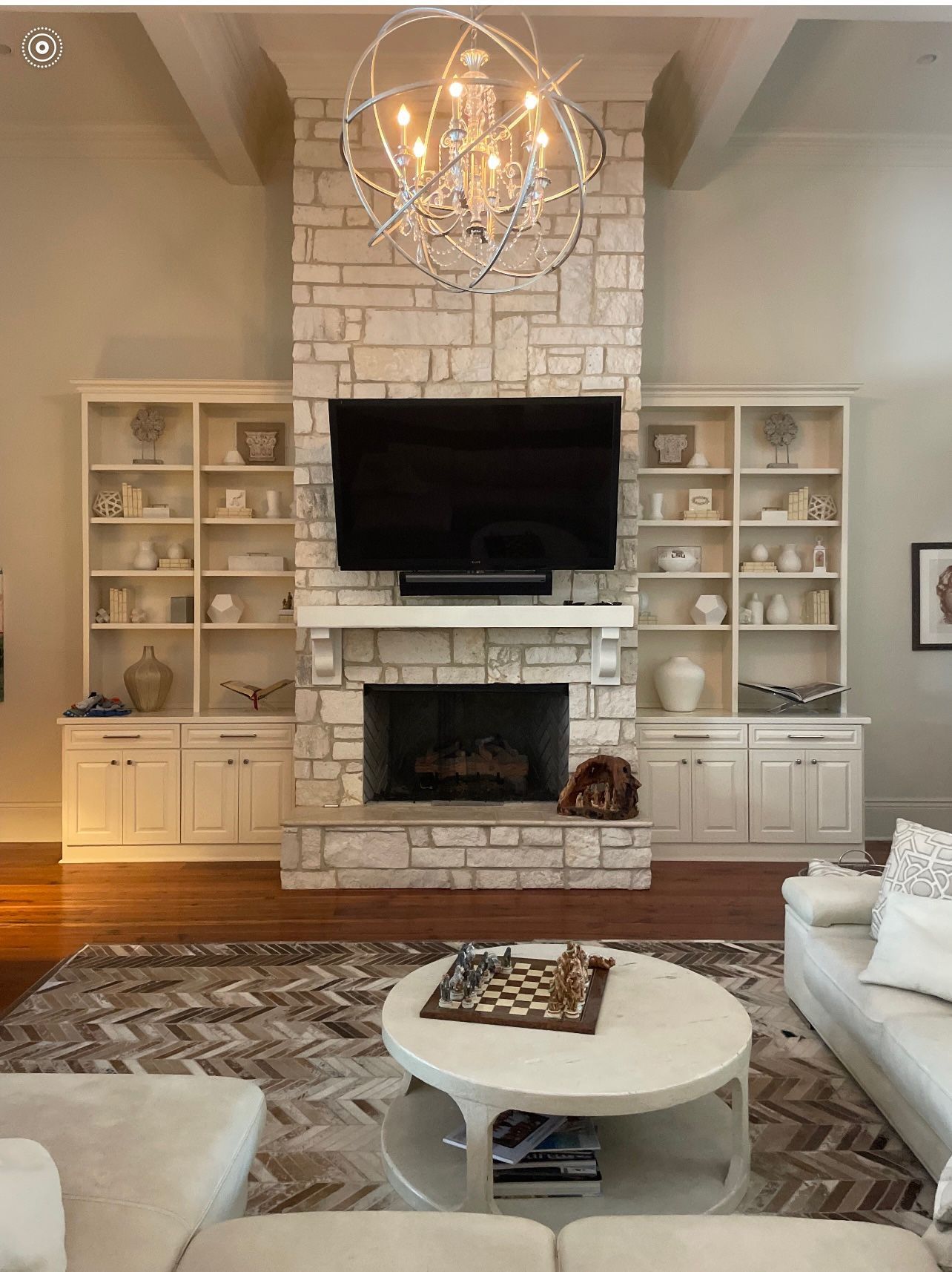 A living room with a fireplace and a flat screen tv