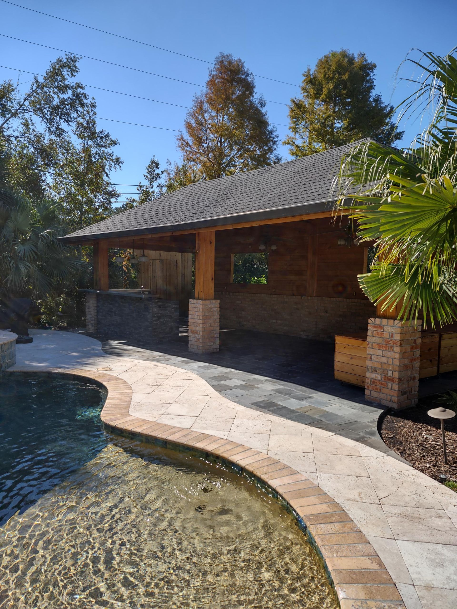 A house with a swimming pool in front of it.