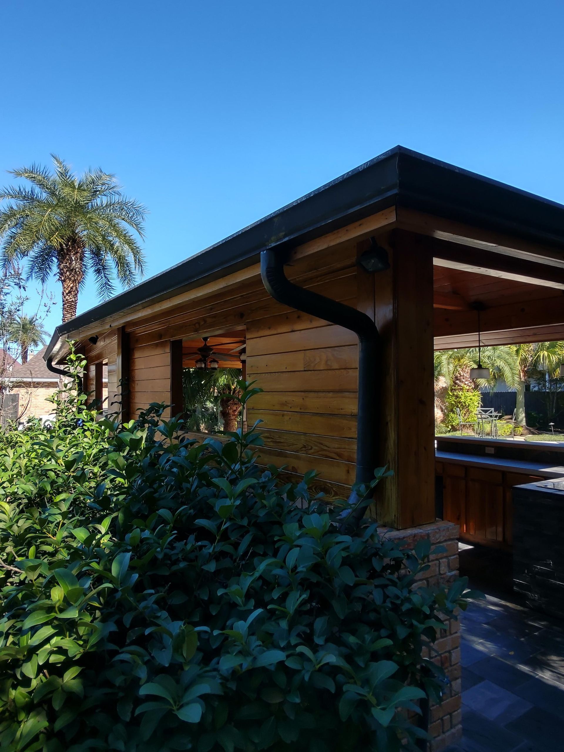 A wooden house with a palm tree in the background