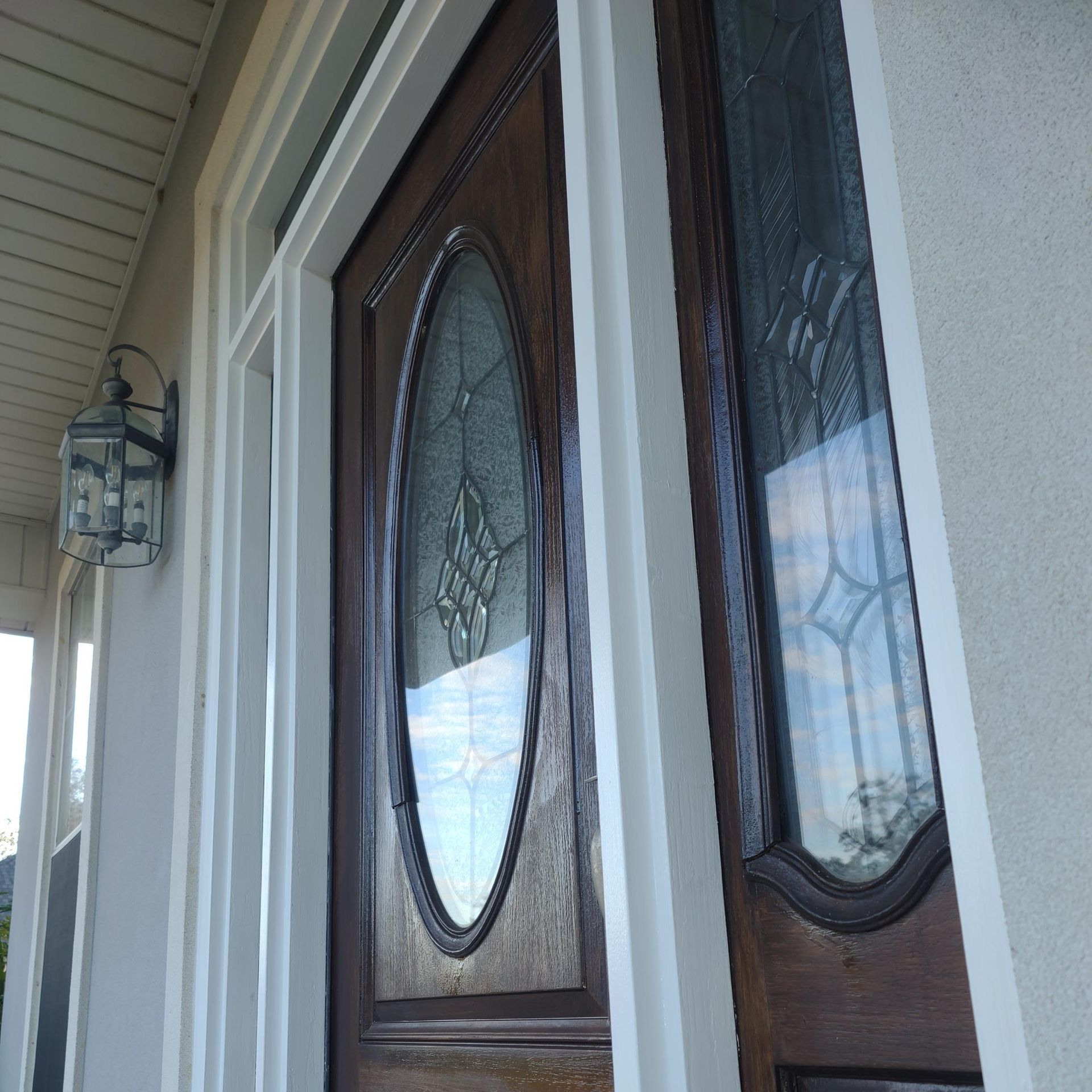 The front door of a house has a stained glass window