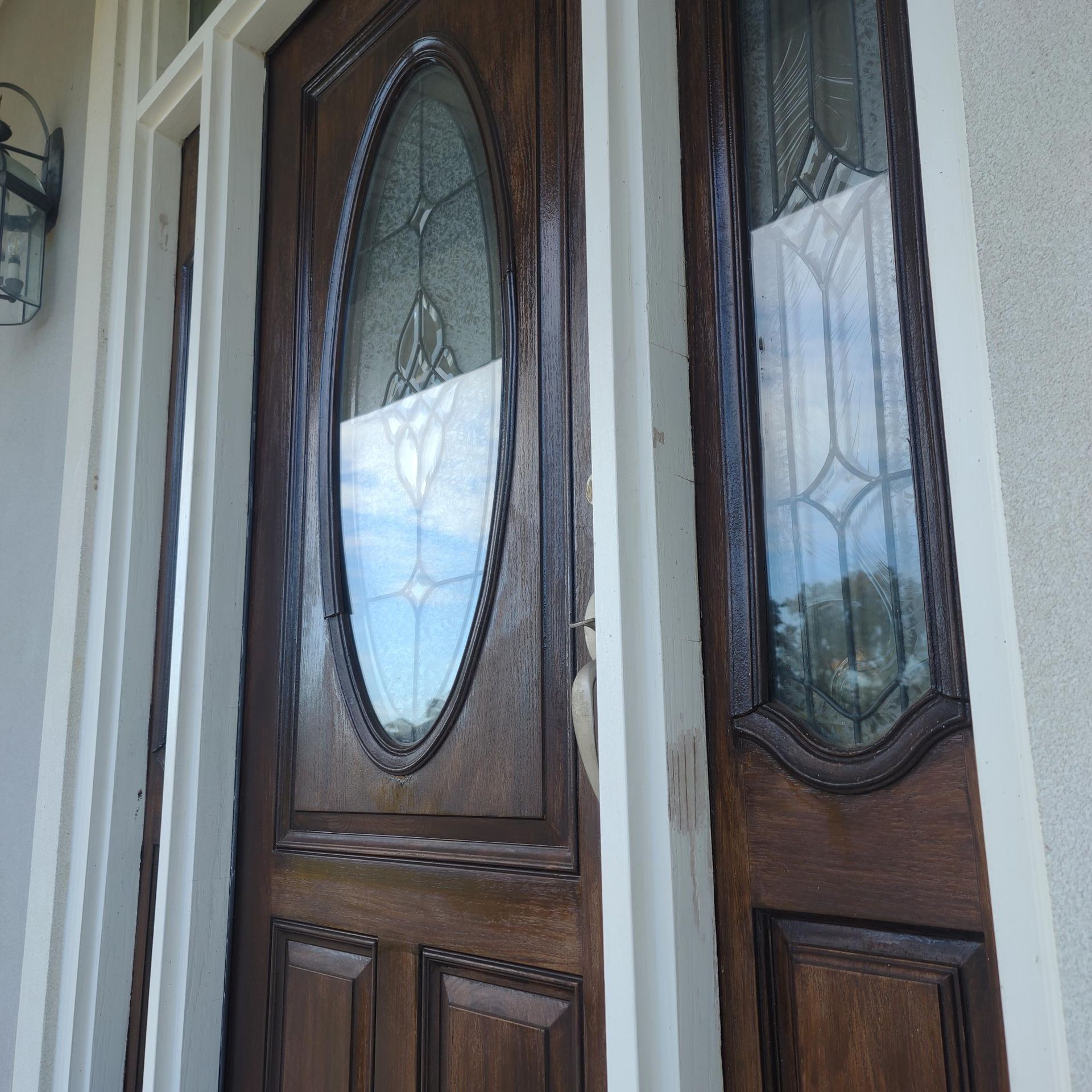 A wooden door with a stained glass window