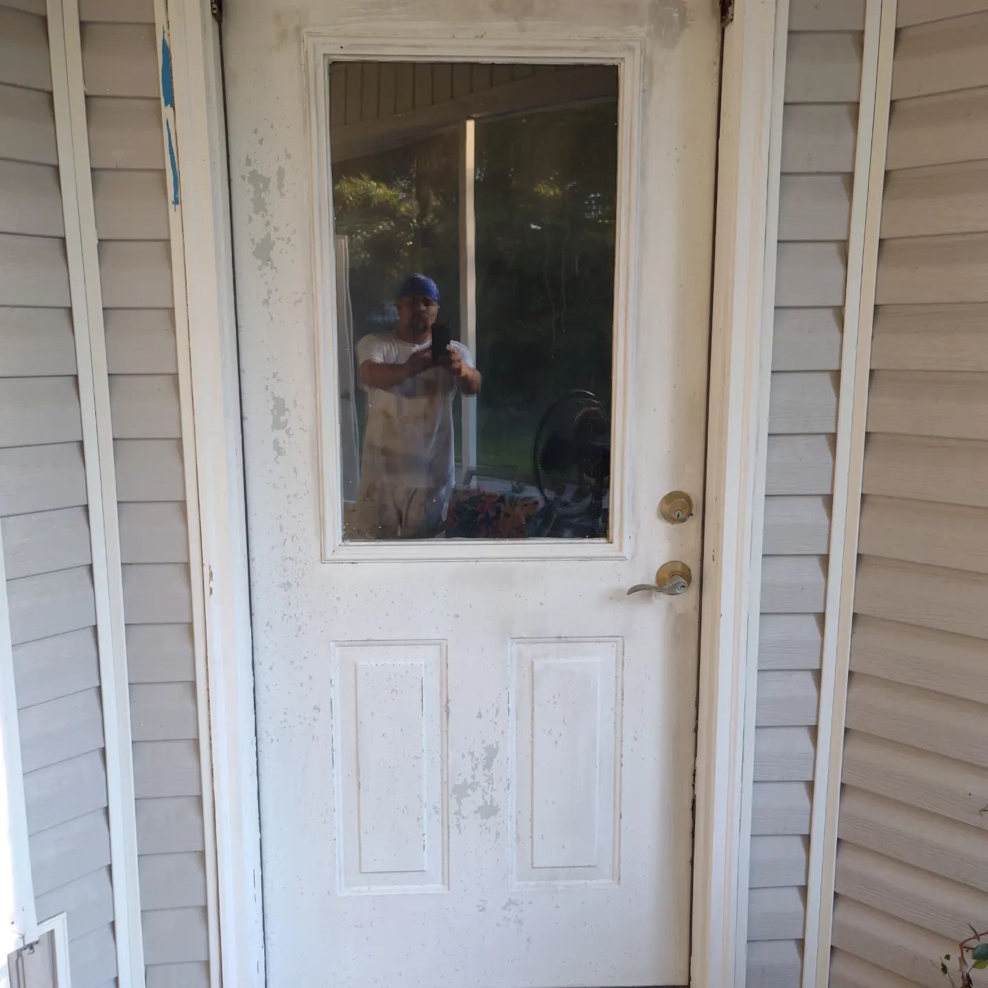 A man is taking a picture of himself in a doorway