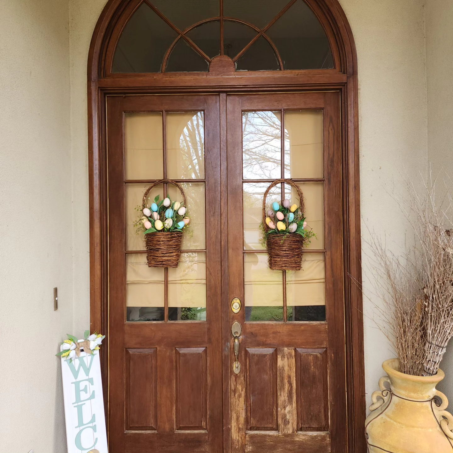 A wooden door with a welcome sign in front of it