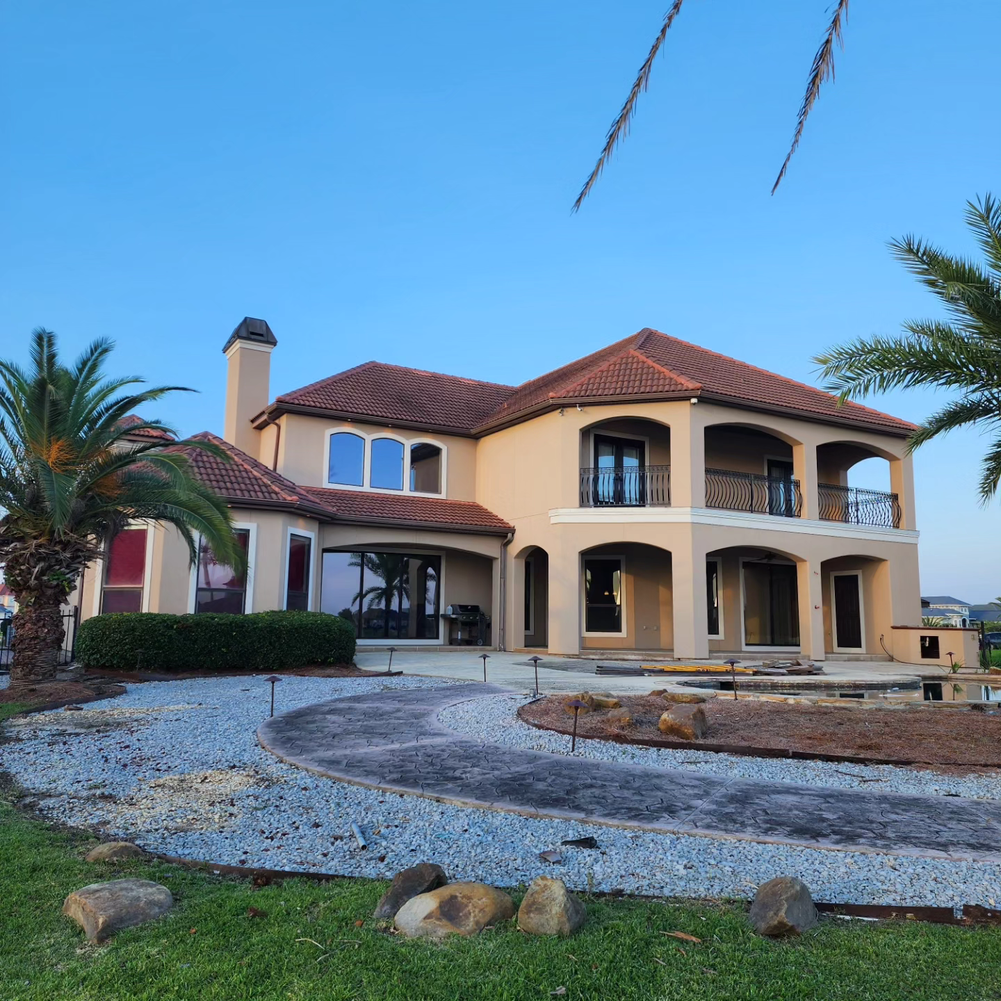 A large house with a palm tree in front of it