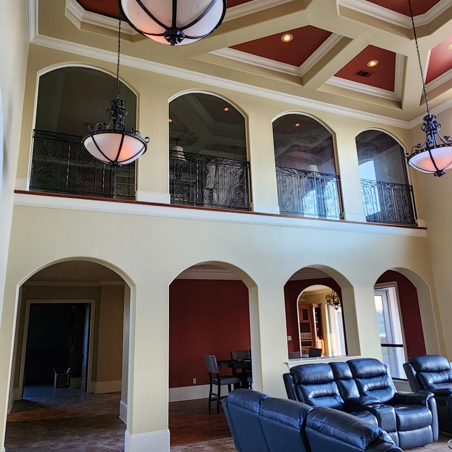 A living room with a couch and chairs and a balcony