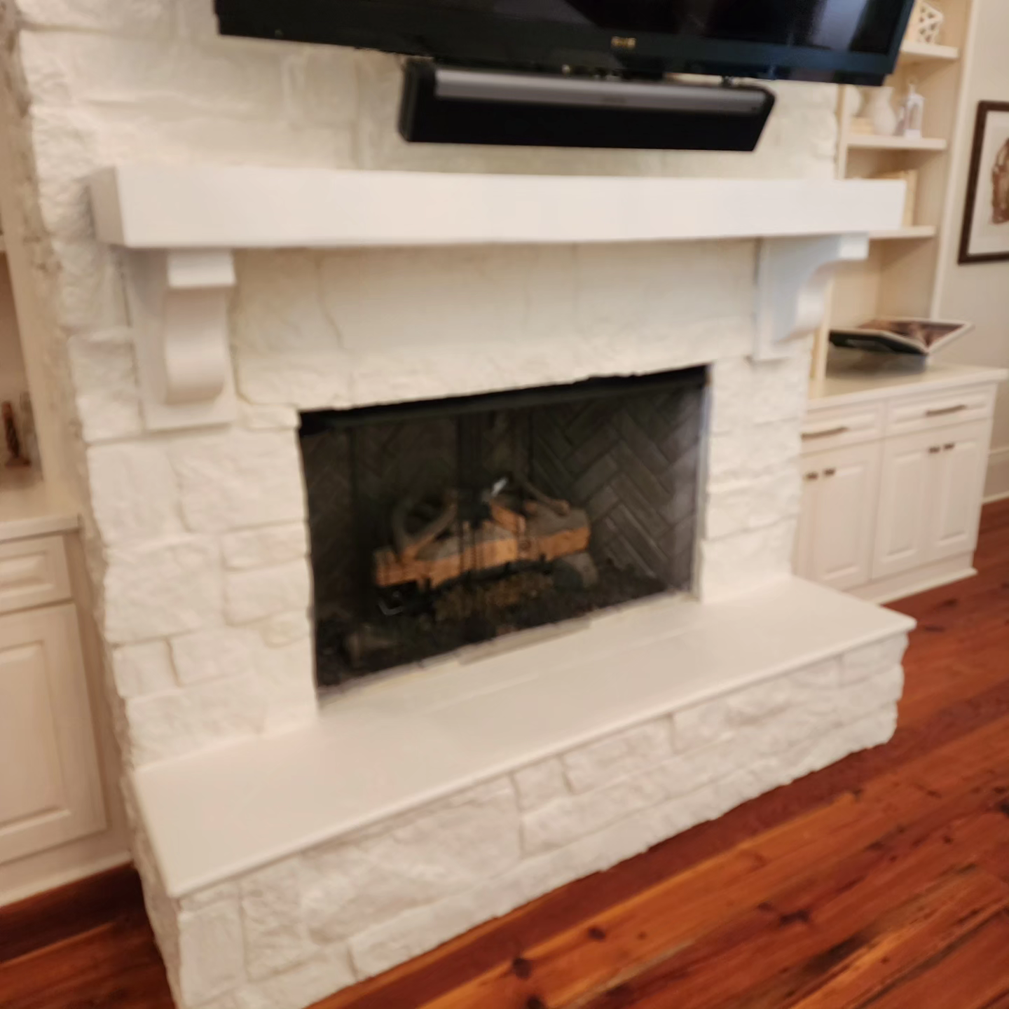 A fireplace with a flat screen tv above it