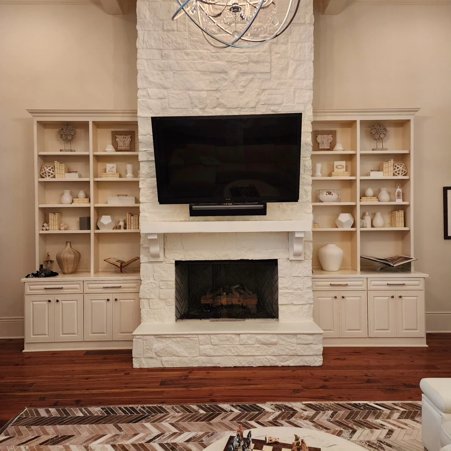 A living room with a fireplace and a flat screen tv