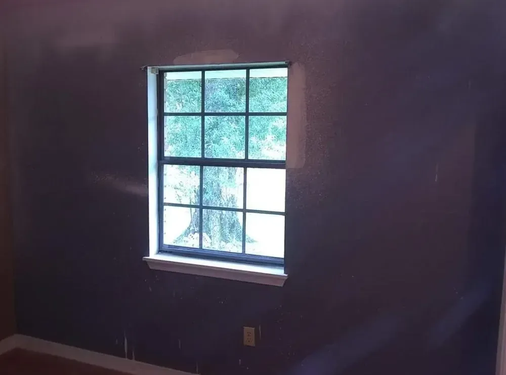 An empty room with a window in the corner