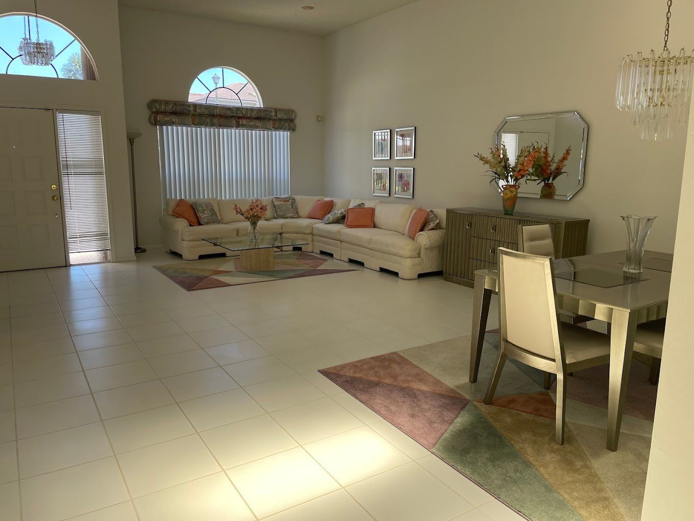 A living room with a couch , table and chairs.