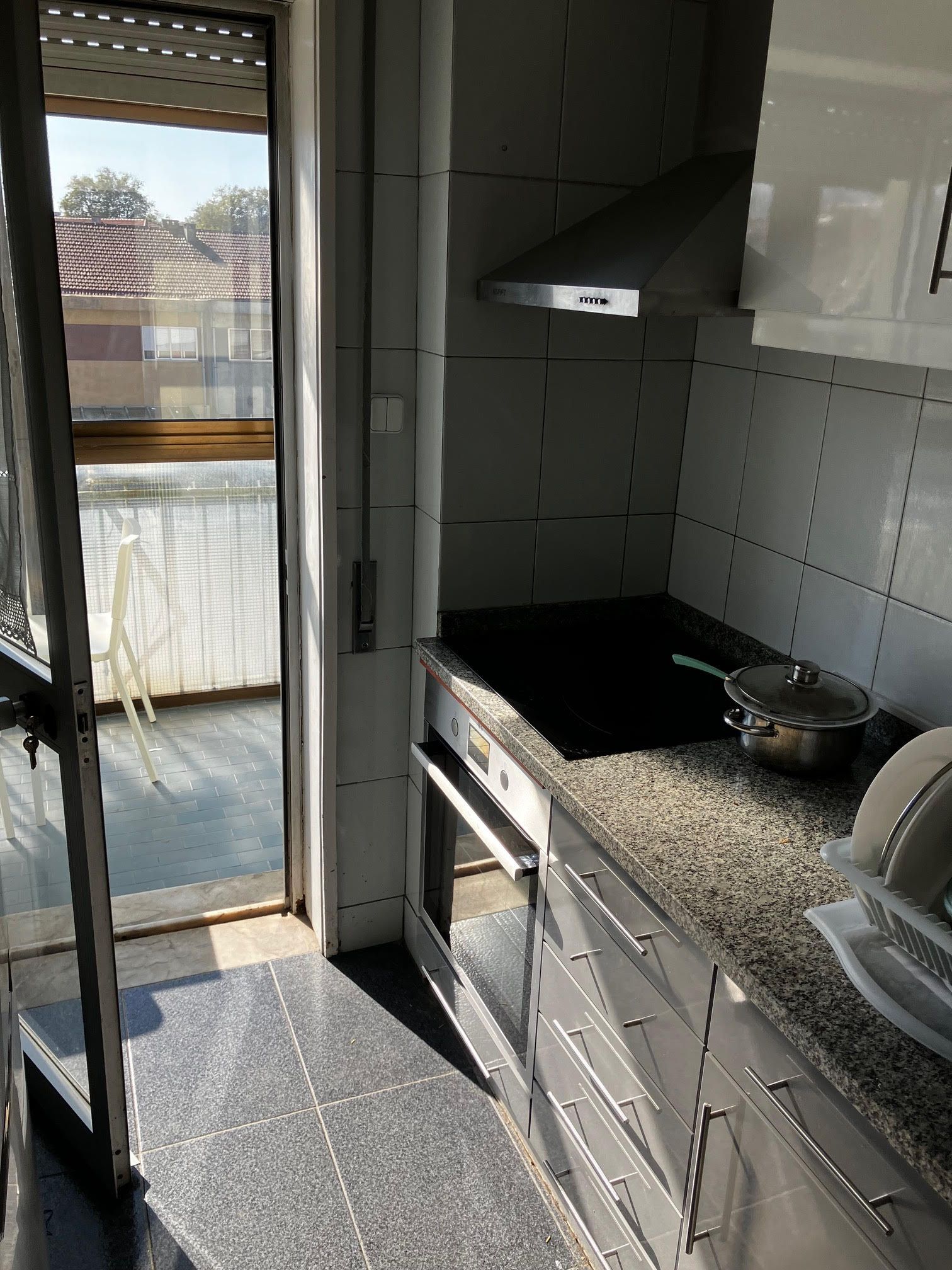 A kitchen with granite counter tops and white cabinets