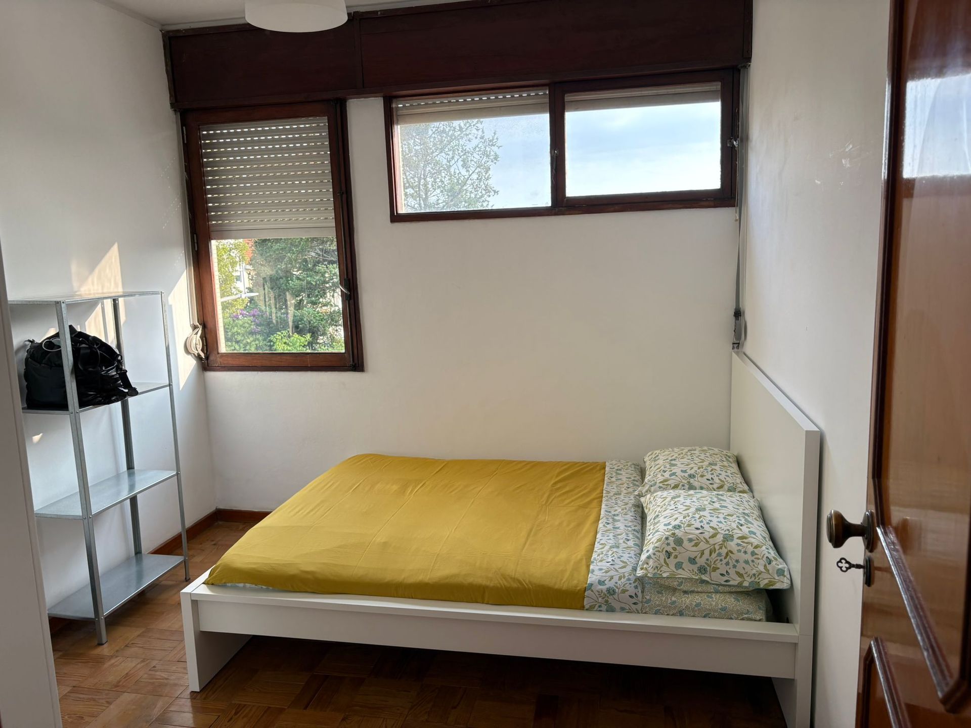 A bedroom with two beds and a desk and chair