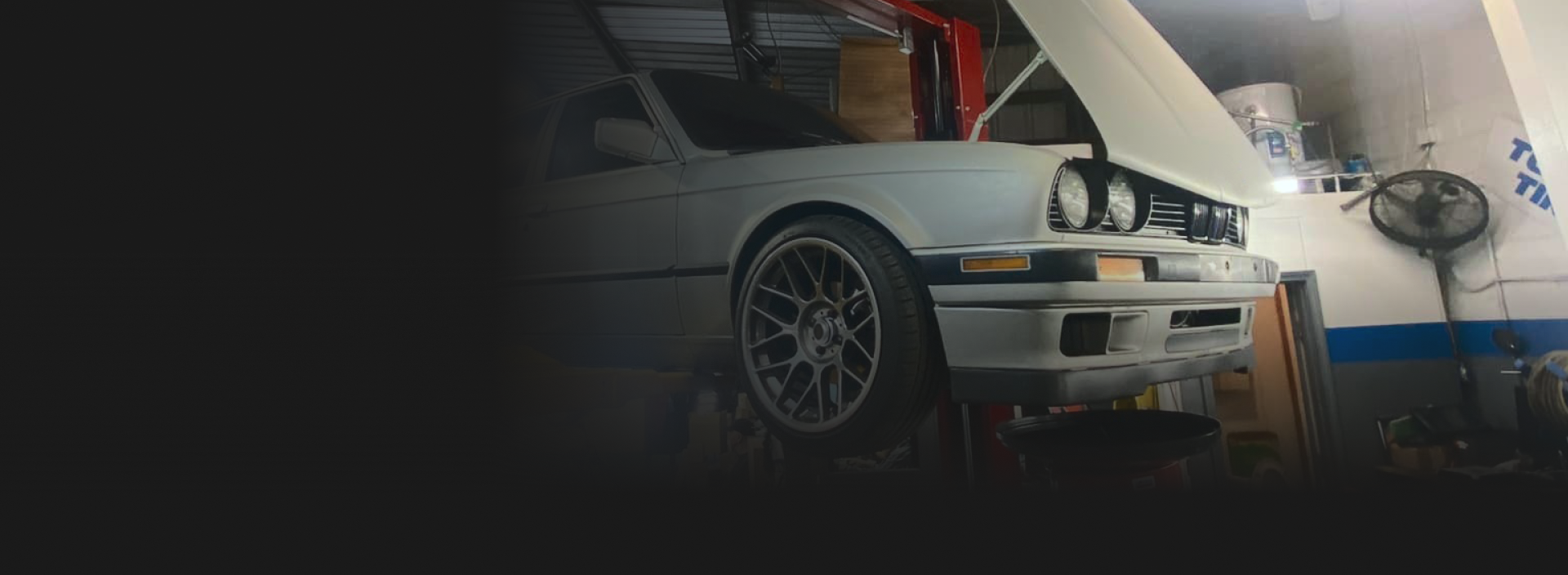A white car with the hood open, parked in a garage. | Allen's Automotive Service