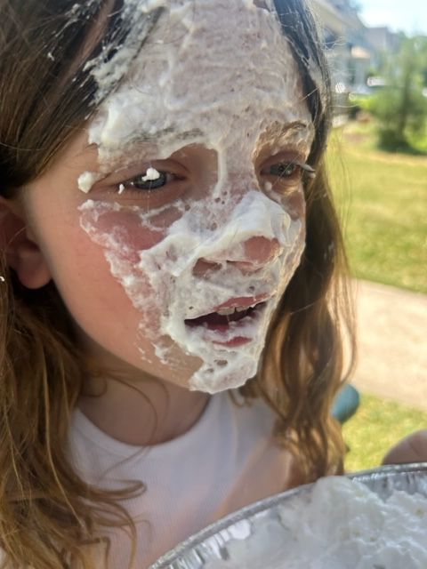 A little girl with frosting on her face