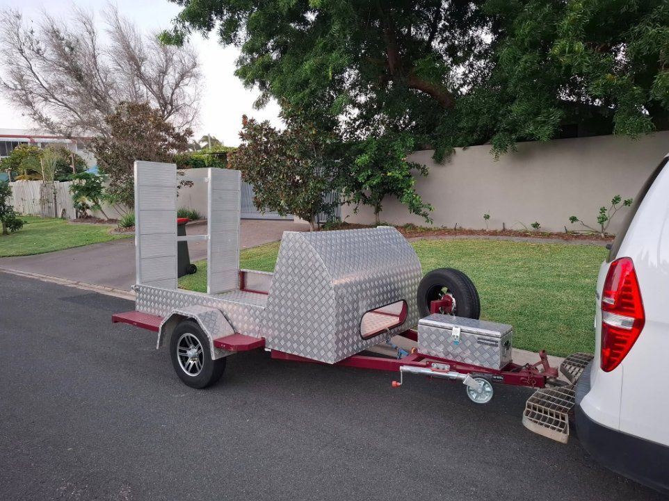 A Trailer is Being Towed by a White Van — Buggies & Batteries in Gladstone, QLD