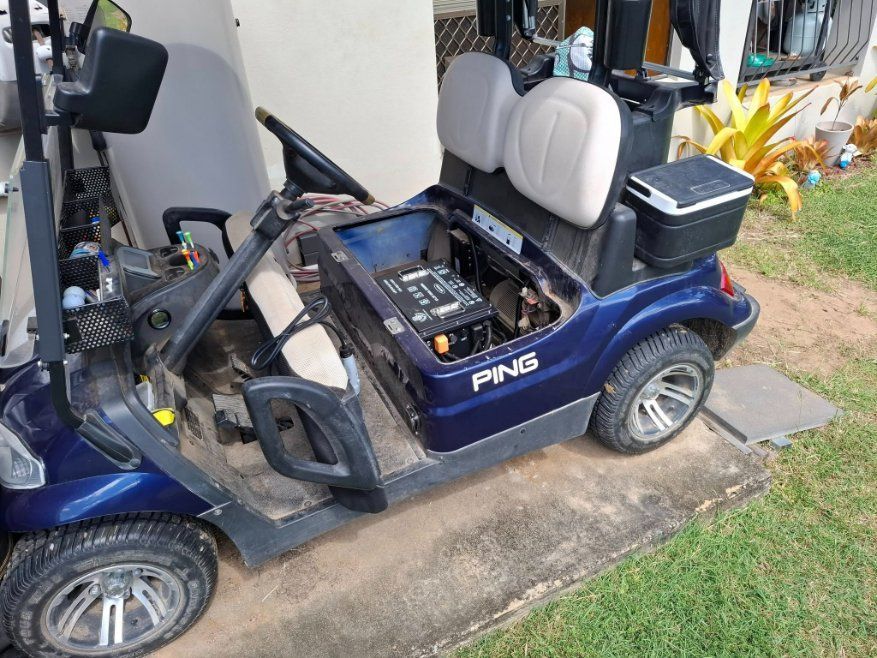 A Ping Golf Cart is Parked on the Side of the Road — Buggies & Batteries in Rockhampton, QLD