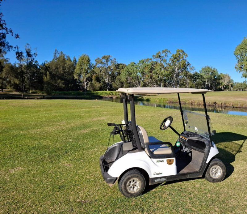 A White Golf Cart is Parked — Buggies & Batteries in Hidden Valley, QLD