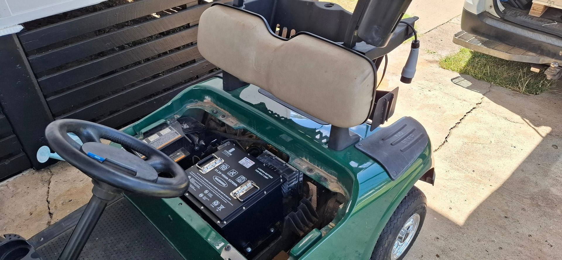 Green Golf Cart With Tan Seat, Parked on Pavement — Buggies & Batteries in Rockhampton, QLD