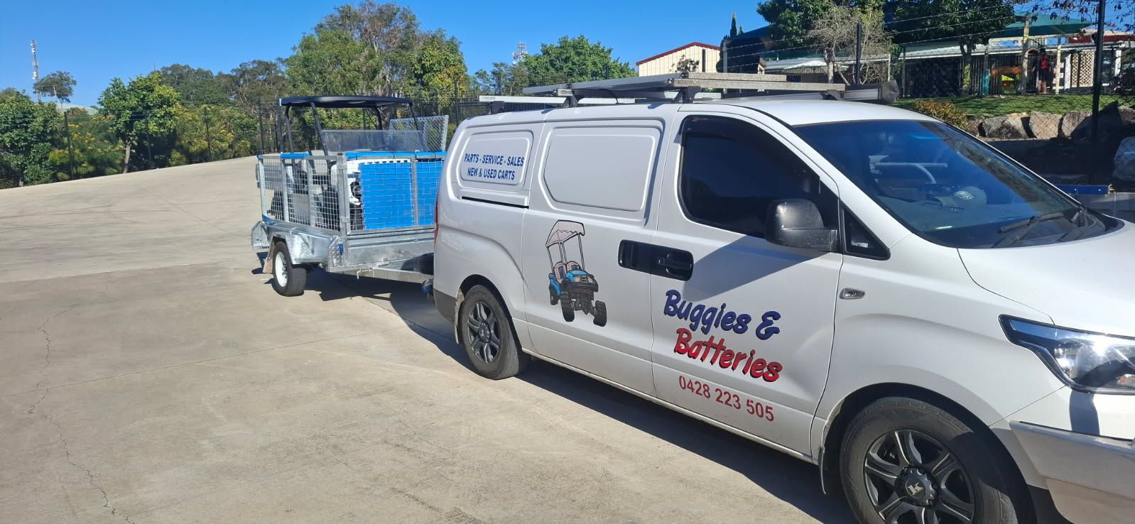 Buggies & Batteries Work Van Towing a Trailer With a White and Black Golf Cart — Buggies & Batteries in Hidden Valley, QLD