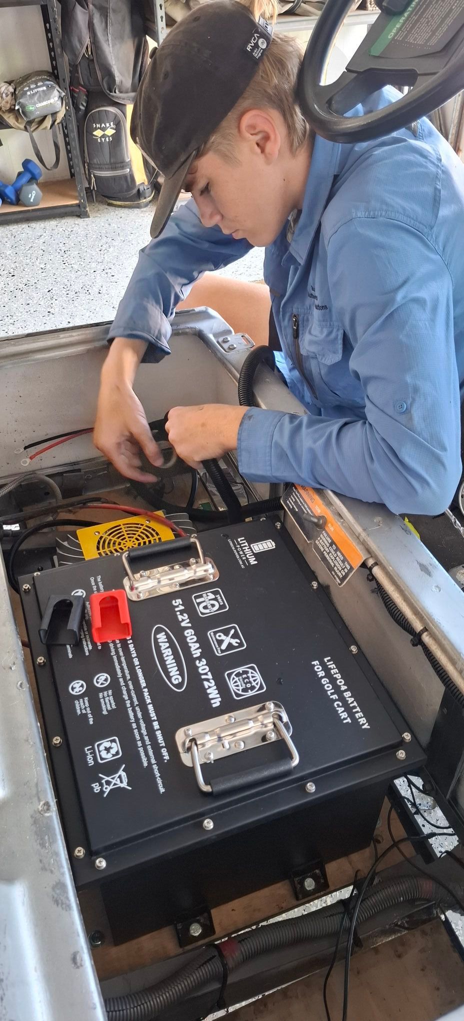 Person in Blue Shirt Working on a Battery — Buggies & Batteries in Emerald, QLD