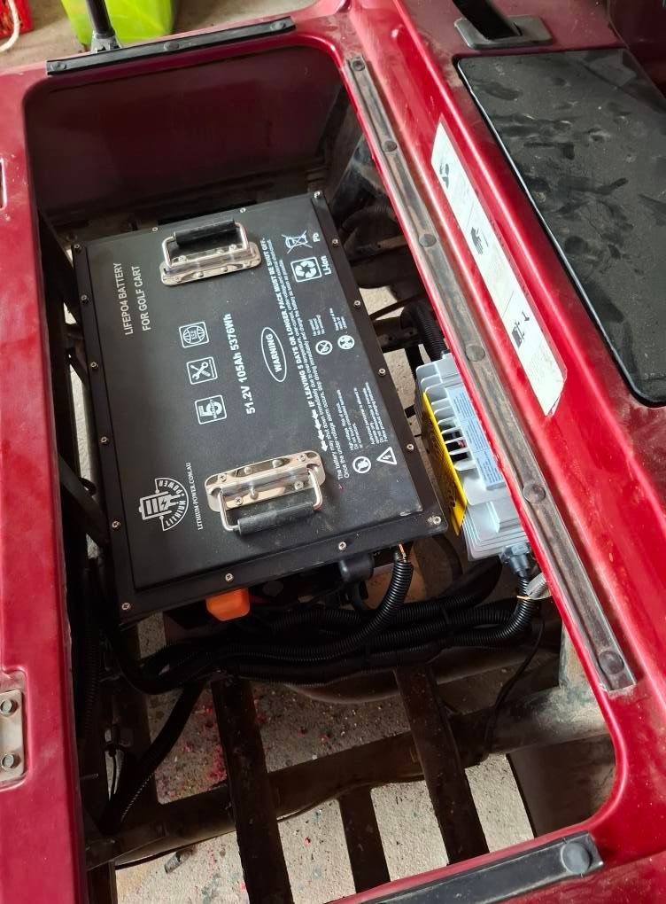 Red Vehicle Compartment With a Black Lithium Battery — Buggies & Batteries in Emerald, QLD