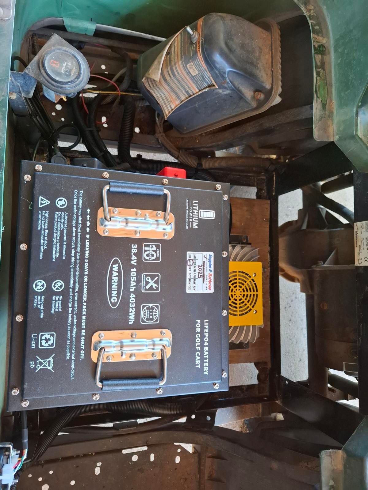 Green Vehicle Interior With a Large Black Battery Pack — Buggies & Batteries in Emerald, QLD