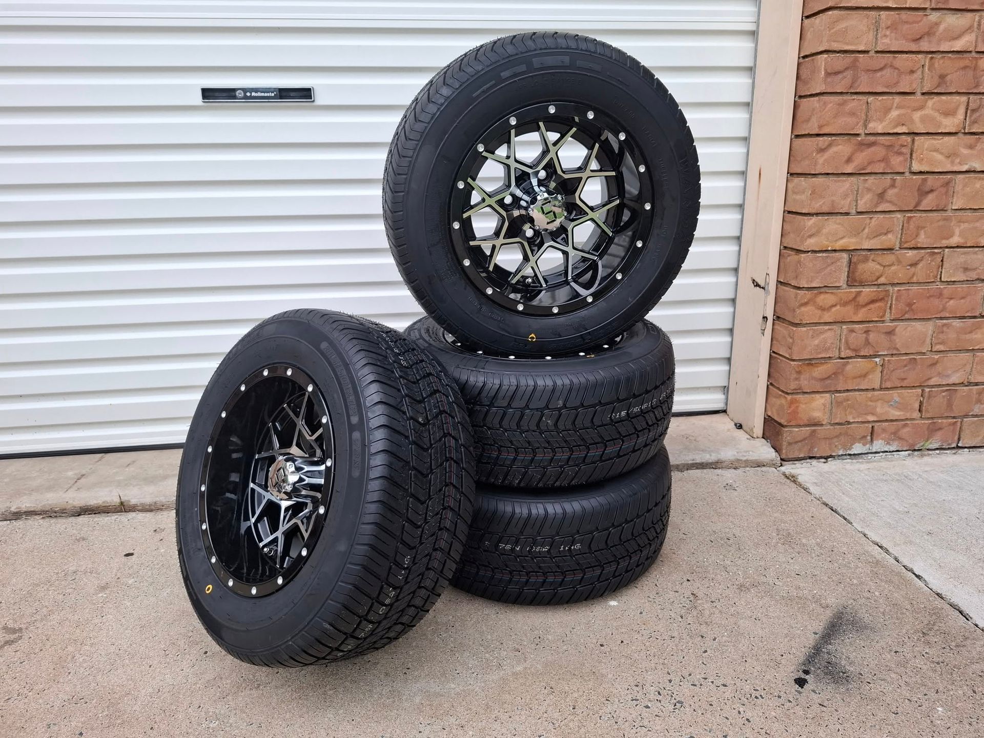 4 Tyres Stacked in Front of a Garage Door — Buggies & Batteries in Hidden Valley, QLD