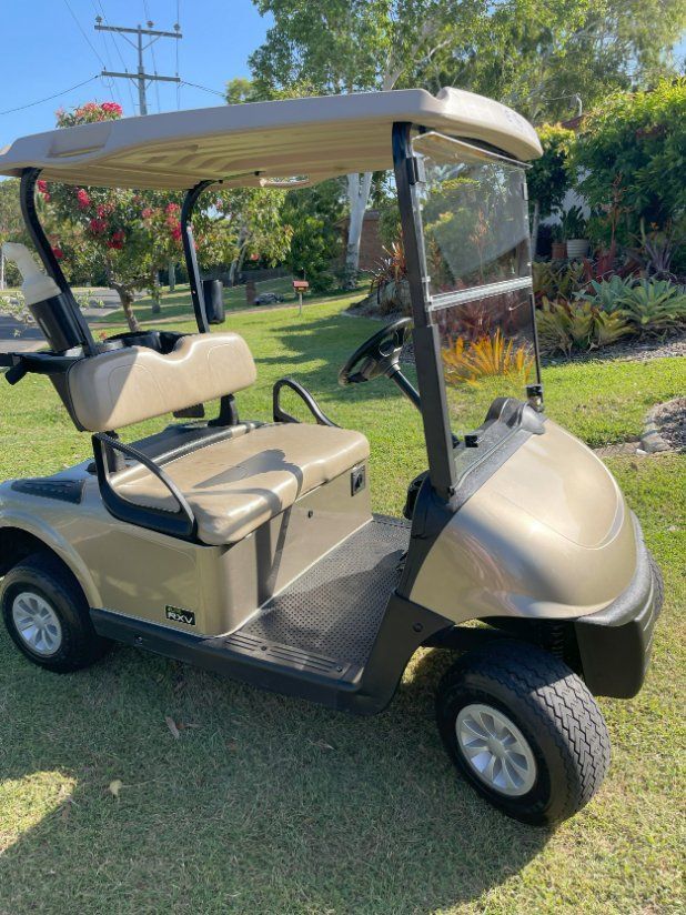 A Golf Cart is Parked on a Lush Green Field — Buggies & Batteries in Hidden Valley, QLD