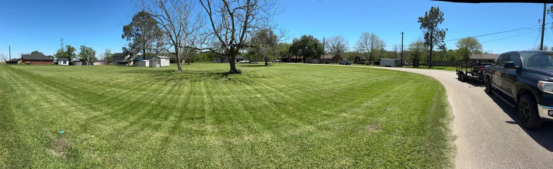 Trees are scattered throughout, and several buildings can be seen in the distance.