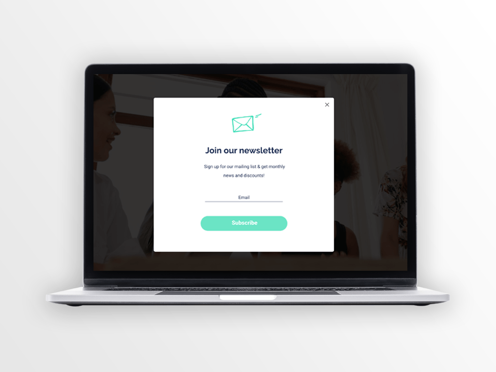 Laptop screen displaying a pop-up for newsletter signup with an email icon and a 