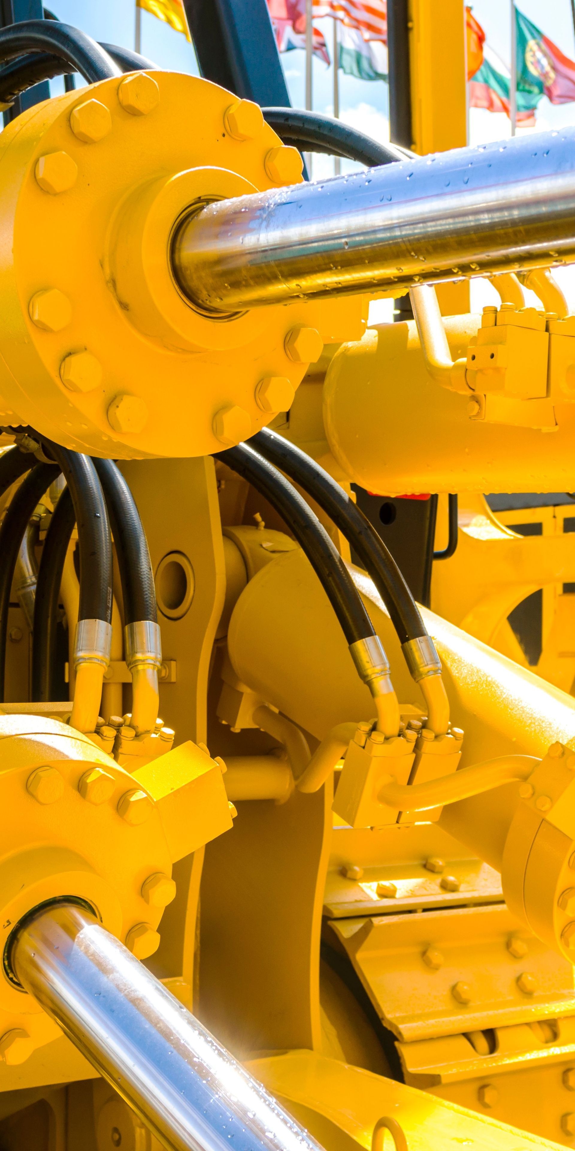 A close up of a yellow hydraulic system.