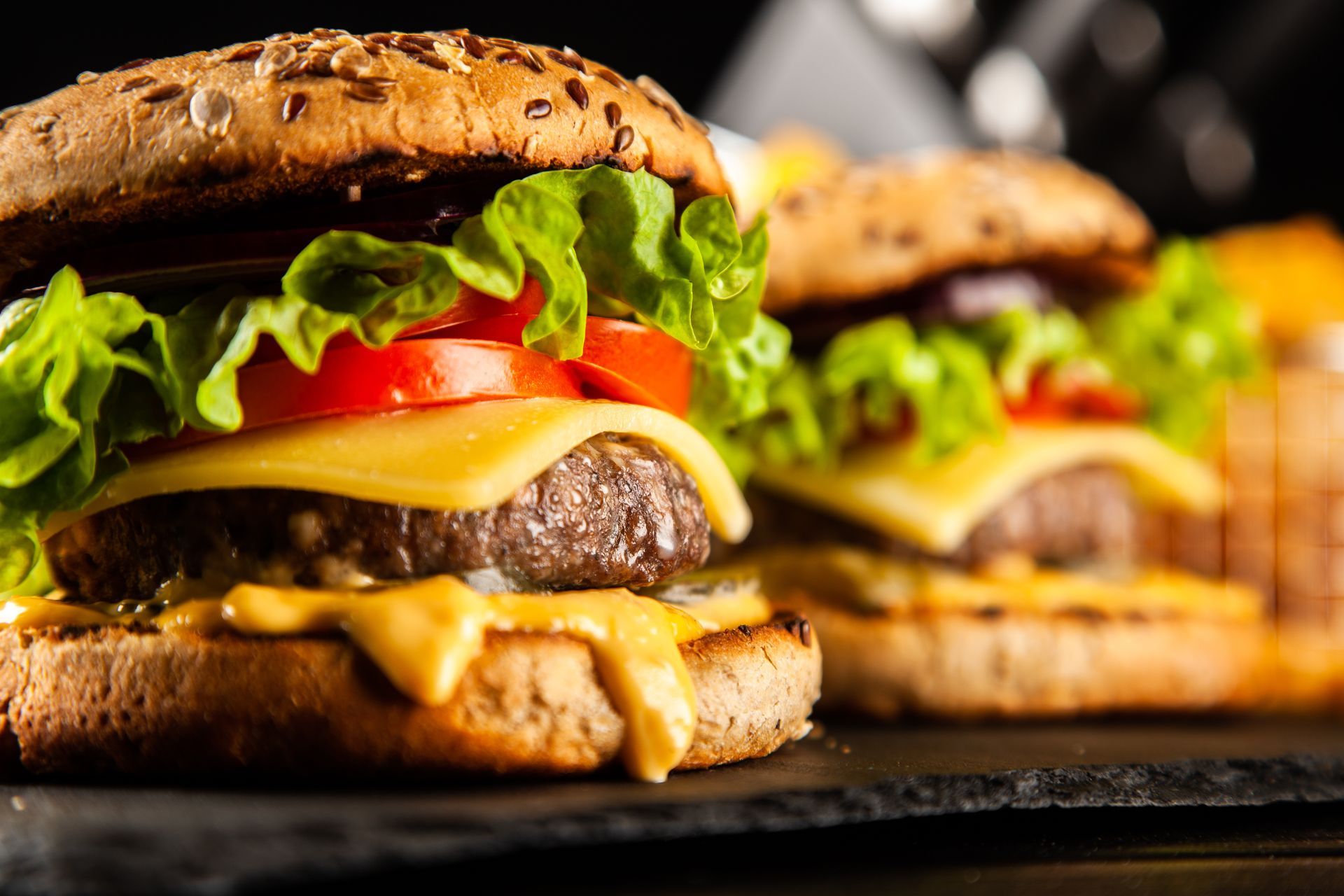 A close up of two hamburgers on a table.