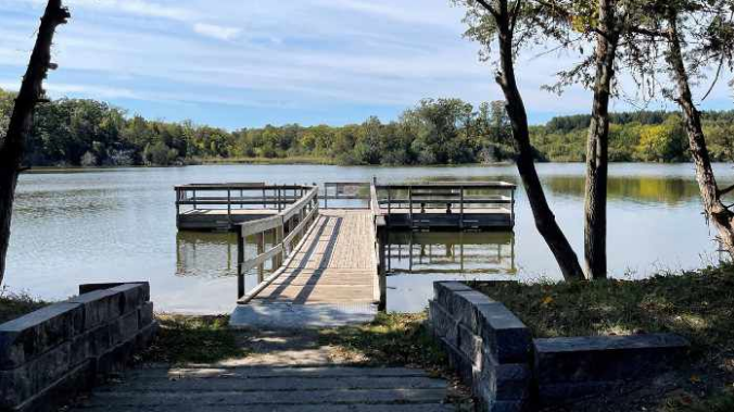 A large body of water with trees in the foreground