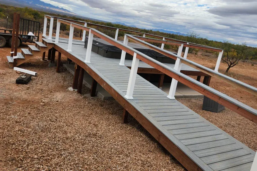 A wooden ramp with white railings is being built in the desert