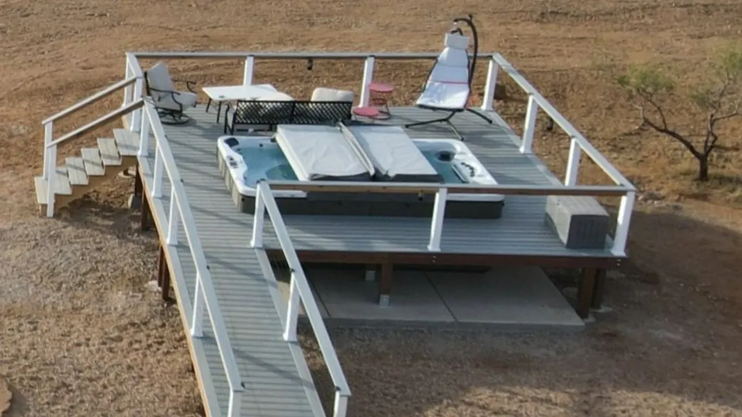 A deck with a hot tub on top of it