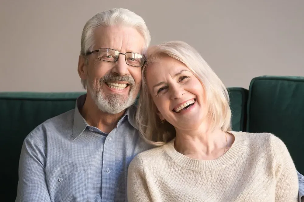 Happy Elderly Couple smiling with dentures