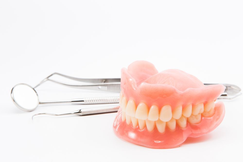 A set of full dentures on a white background.