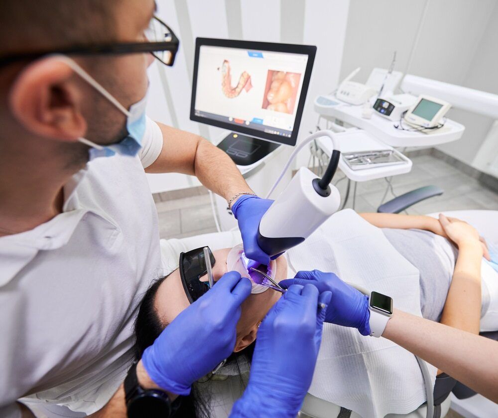 Dentist Using Scanner on Patient in Dental Chair — The Denture Care Group Sunshine Coast in Caloundra, QLD