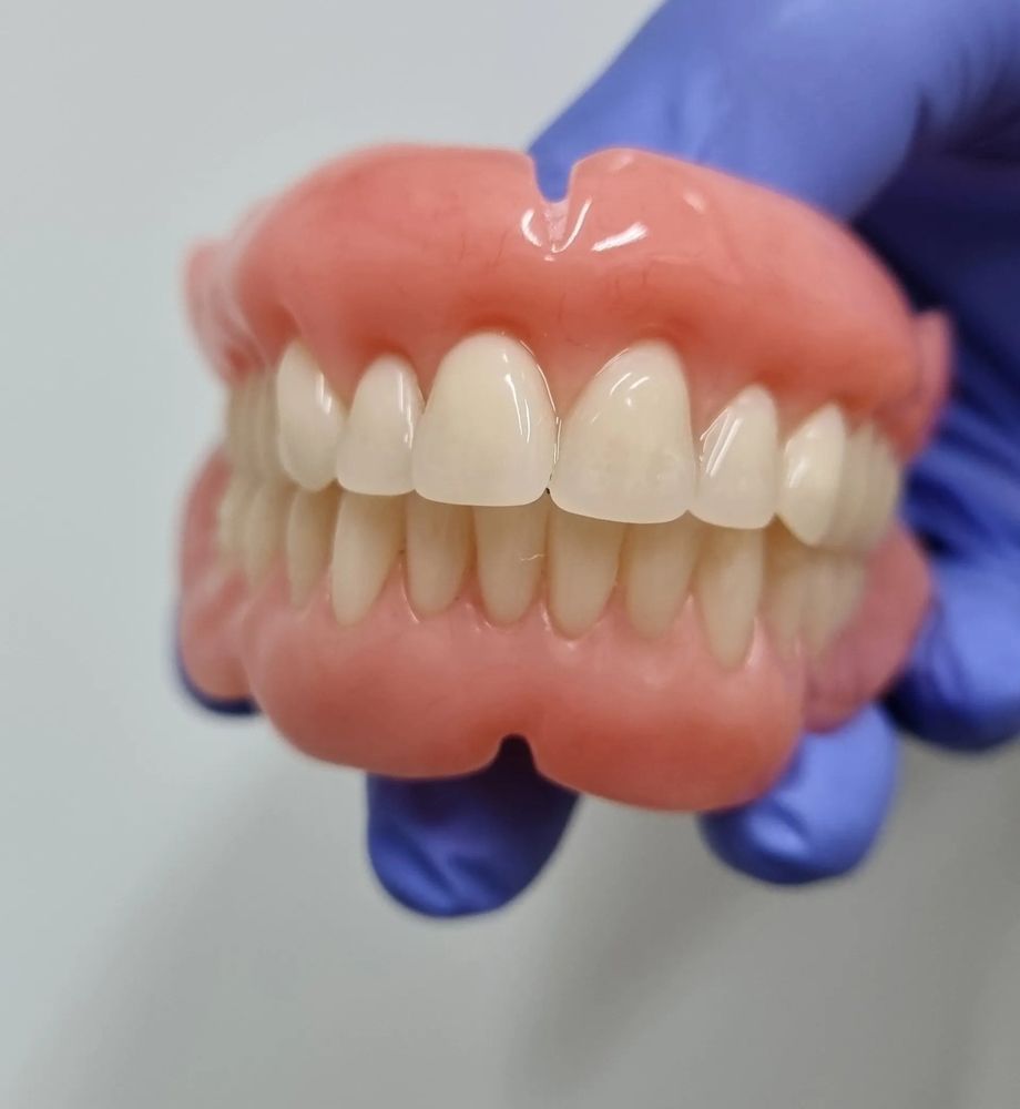 Dentist Holding Denture Replacement