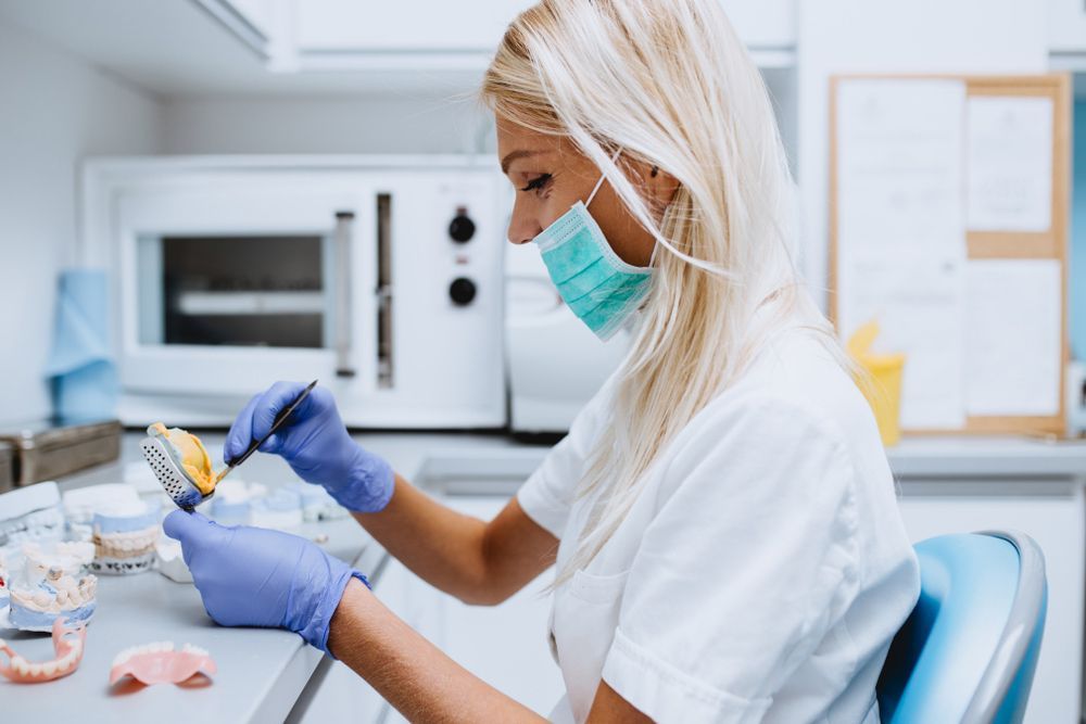 Dentist Working on Dentures