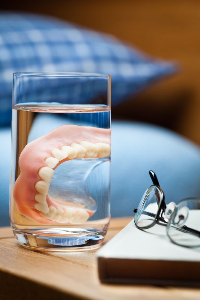 Dentures In A Glass On Bedside