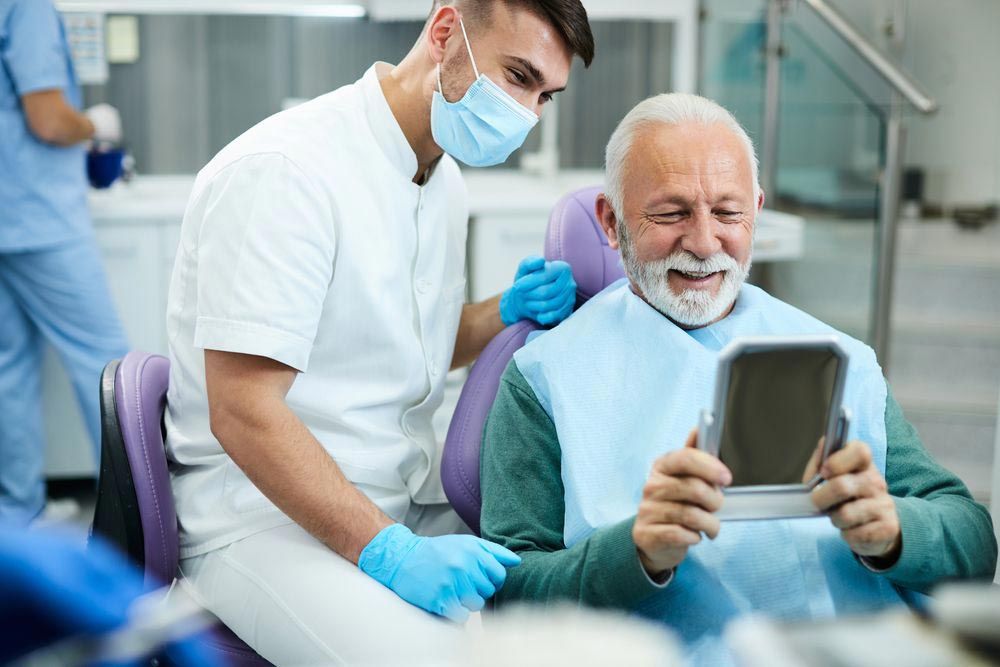 Man Checking His Dentures At A Denture Clinic
