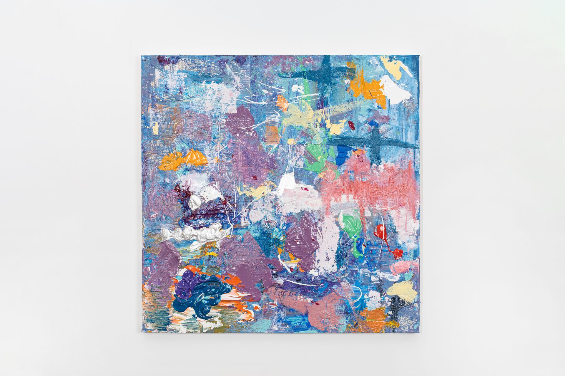 A colorful painting is hanging on a white wall.