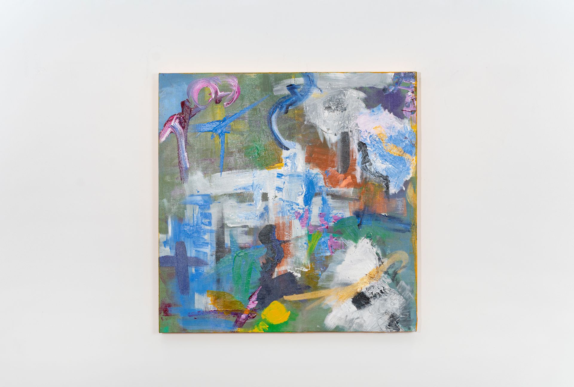 A colorful painting is hanging on a white wall.