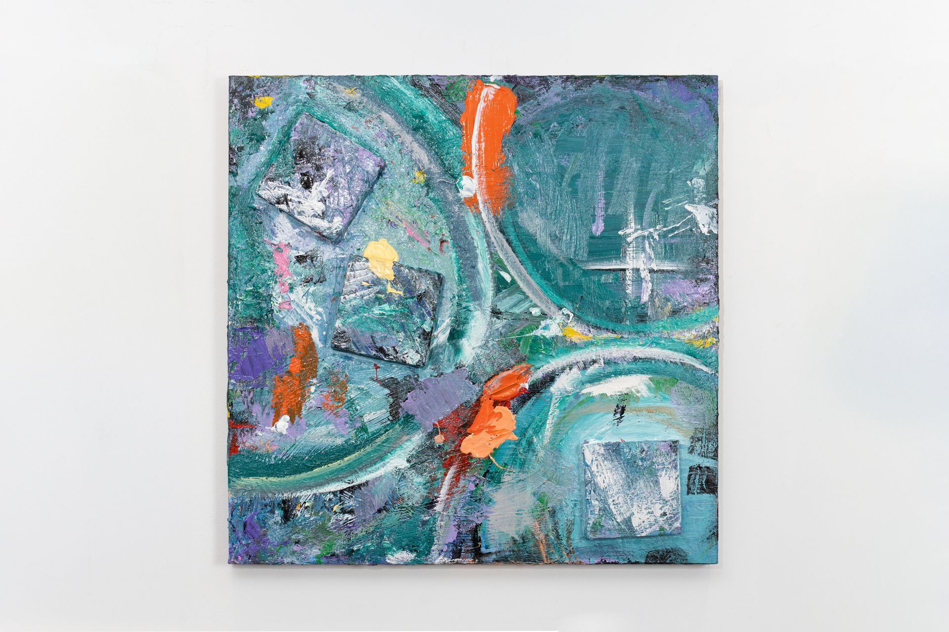 A colorful painting is hanging on a white wall.