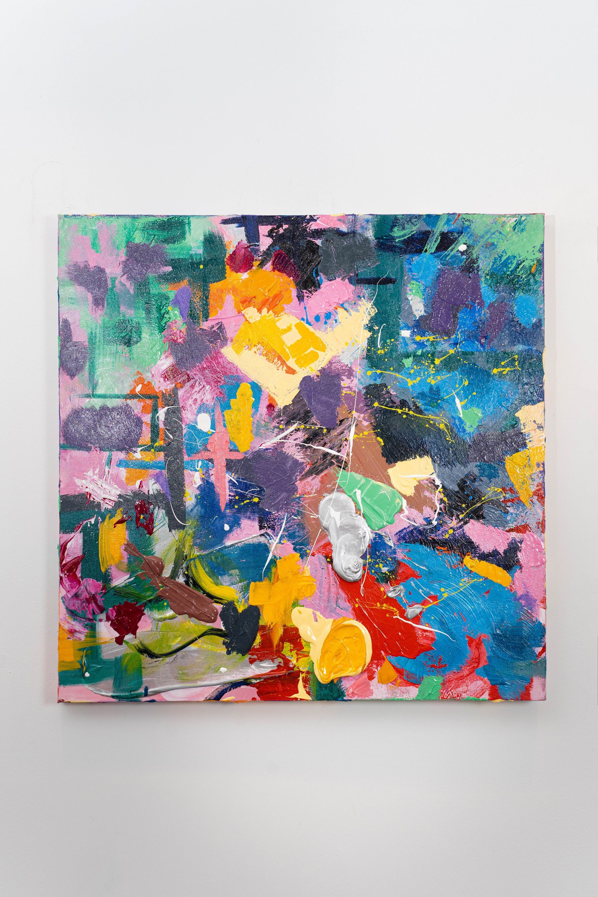 A colorful painting is hanging on a white wall.