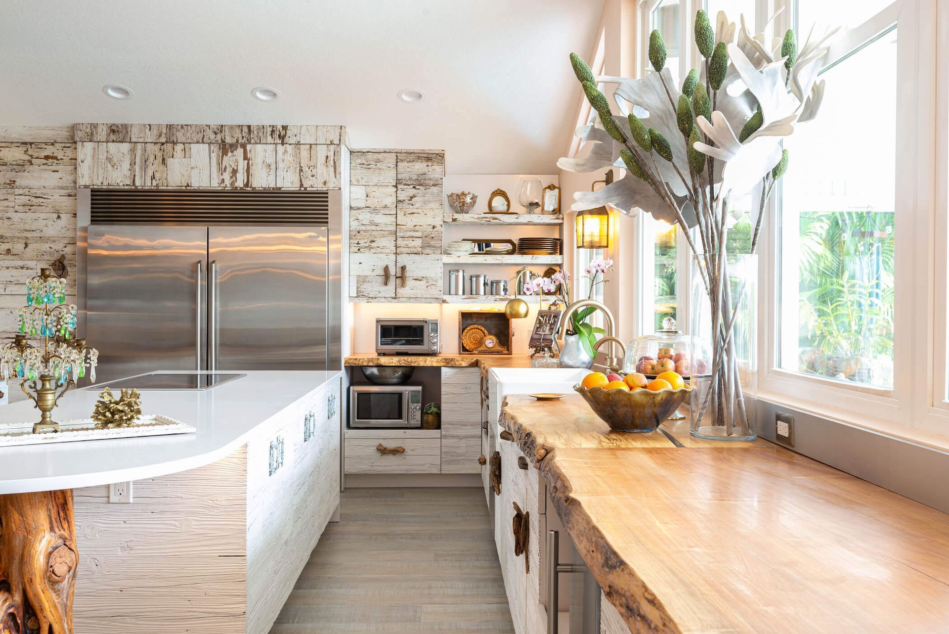 Rustic kitchen with wood and white accents, stainless steel appliances, and a window with a view.