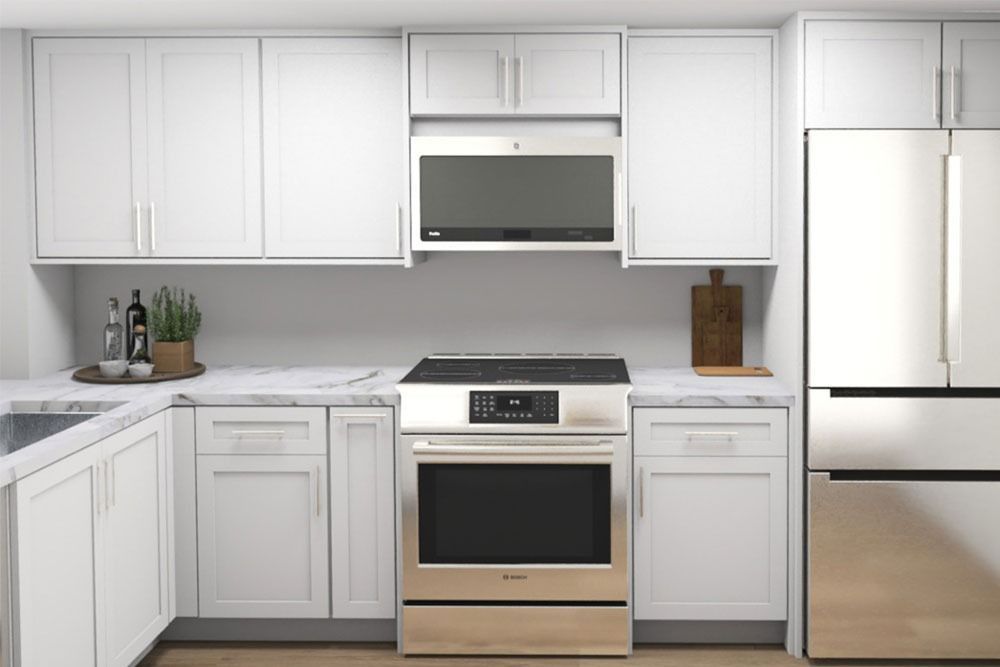 White kitchen with cabinets, stainless steel appliances, and marble countertops.